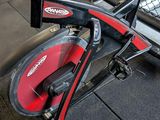 a red and black exercise bike in a gym