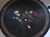 a black table with a flower design on it