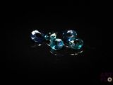 some very pretty blue diamonds on a black surface