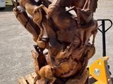 a wooden sculpture on a pallet in a parking lot