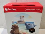 the box is open on the table with a toy animal on it