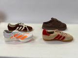 several pairs of shoes are lined up on a white surface