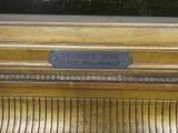 a close up of a gold piano with a plaque on it
