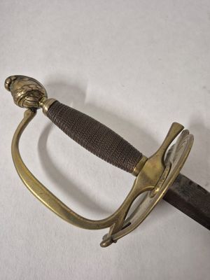 a sword that is laying on a white surface