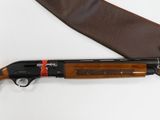 a shotgun and a knife on a white surface