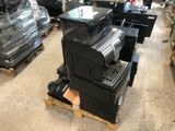 a stack of black and silver appliances on a pallet in a store
