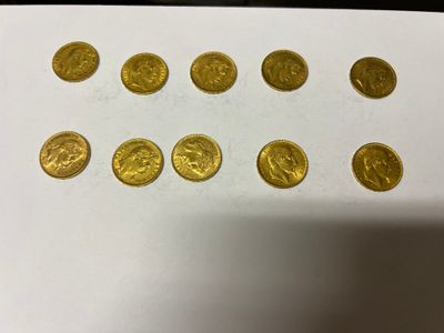 a bunch of gold coins sitting on top of a white table