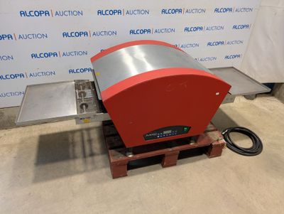 a close up of a machine on a pallet with a sign in the background