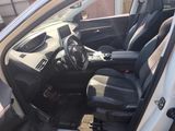 the interior of a car with the door open and the driver ' s seat down