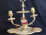 an image of a three - tiered candle holder with three candles on it