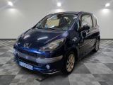 a picture of a small blue car parked in a garage