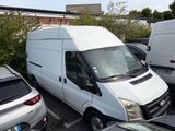 a white van parked in a parking lot next to other cars