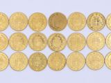 a lot of gold coins on a white surface