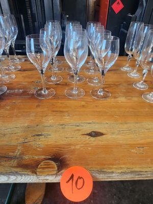 many empty wine glasses sitting on a wooden table