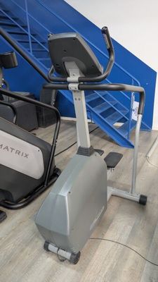 a stationary exercise bike and a stationary exercise bike in a gym