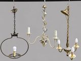 three chandeliers hanging from a metal pole with candles on them
