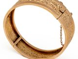 an image of a gold bracelet with a chain on a white background