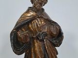 bronze figurine of a man holding a bag of money