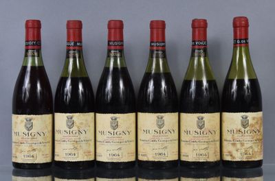 six bottles of wine are lined up in a row on a table
