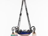 a blue and white chandelier with two lamps hanging from it