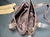 a purse that is sitting on a table next to a bag