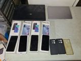 a lot of different cell phones and laptops on the table