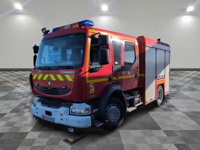 a red fire truck that is parked in a room