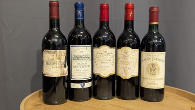 six bottles of red wine are lined up on a wooden tray