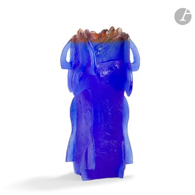 a blue glass vase with a blue dress on it