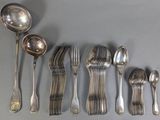several spoons, forks, and spoons are lined up on a table