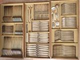 many forks and spoons in a wooden box