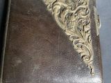 an old leather case with a decorative design on the front