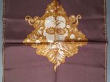 an image of a purple and gold handkerchief with a picture of a man