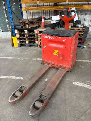 a fork lifter that is sitting in a warehouse