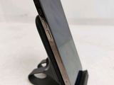 a cell phone that is sitting on top of a stand