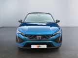 the front view of a blue car in a white room