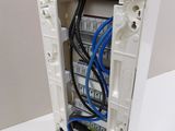 a white box with a bunch of wires inside of it