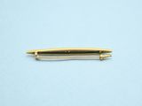 a gold pen sitting on top of a blue surface