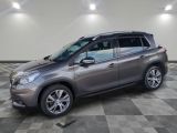 une voiture grise garée dans un garage au sol en damier