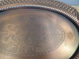 a large metal tray with a decorative design on it