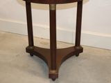 a small wooden table with a marble top on it