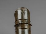 a close up of a metal object on a gray surface