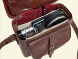 a brown leather bag with a camera inside of it
