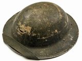 an old helmet is worn on the side of a white background