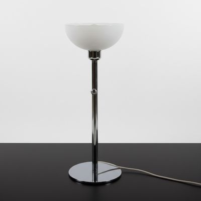 a close up of a table with a lamp on it