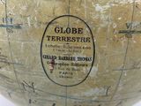 a globe on a wooden stand with a map on it