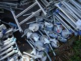 a pile of old metal pipes and wheels on the ground