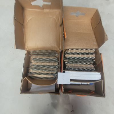 two boxes with a bunch of nails inside of them