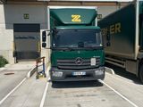 two trucks that are parked in a parking lot