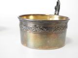 a small metal bowl with a spoon in it